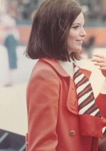 Katherine in Central Park wearing the tomato pantsuit that inspired the outfit Cat Velis wore to work across from the UN in The Eight