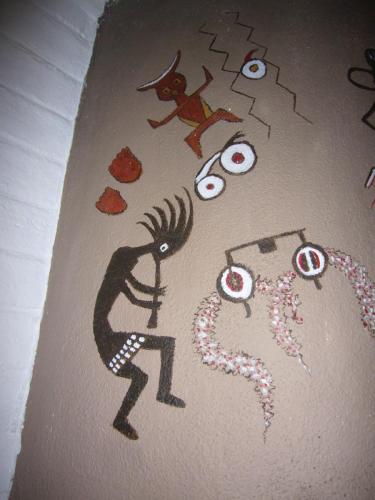 Kokopelli playing her flute, footprints of the girl who stomped the clay and gave birth to the Water Jar Boy